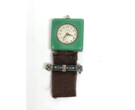 An Ollendorff silver and green enamel case lapel watch with signed 15 jewel manual wind movement numbered 45981, the case sig