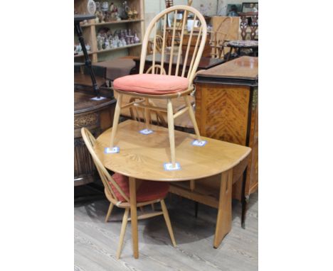 An Ercol blonde drop leaf table and two chairs.Condition - good, no dame/repairs, minor wear only including minor lights mark