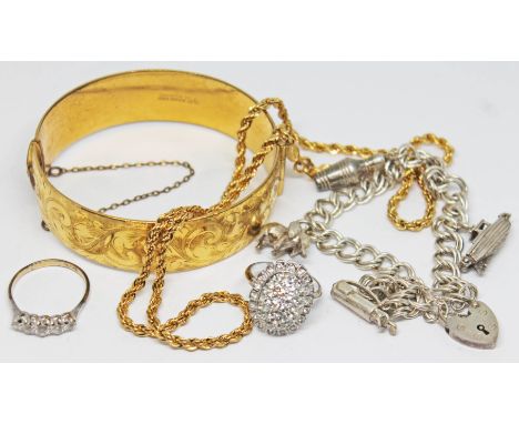 A mixed lot of jewellery comprising a rolled gold bangle, a hallmarked silver charm bracelet, a ring marked '9c', a gold plat