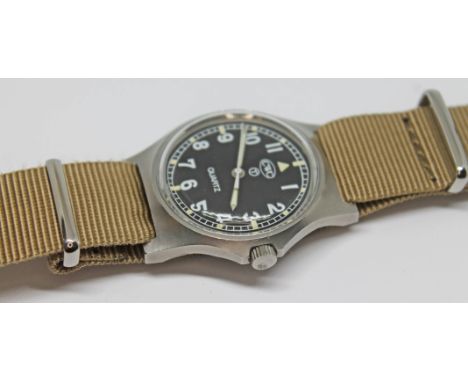 A 1980 CWC British military issue stainless steel quartz wristwatch, the signed black dial having Roman numerals in white, ou