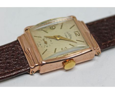 A vintage 14k gold Emerson Watch Co art deco style wristwatch, the dial signed Alexora with hands, hour markers and Arabic nu