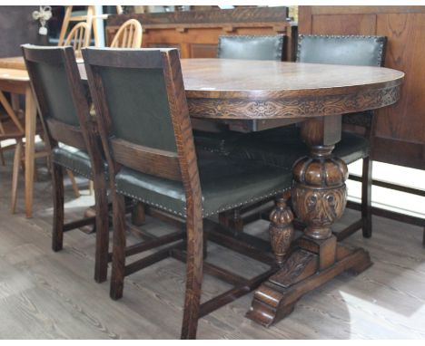 A 1930s Jacobean style carved oak oval extending dining table with bulbous supports and plain stretcher, together with four s