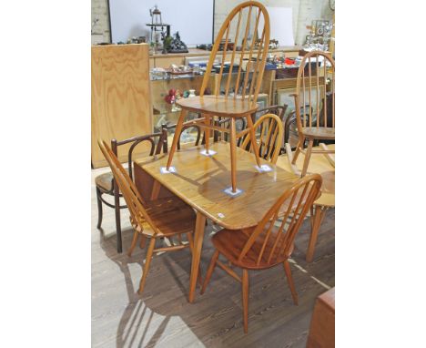 An Ercol blonde elm drop leaf table and four spindle back chairs, max length 138cm, width 74cm.  Condition: no signs of any m