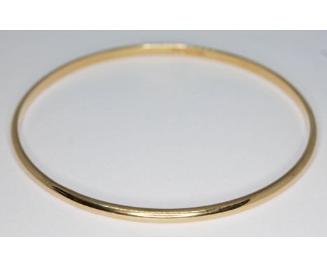 A hallmarked 9ct gold bangle, diam. 65mm, wt. 10.83g.  Condition - good, no damage/repair, minor wear.