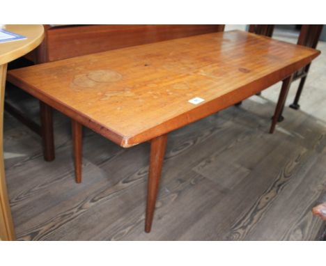 A Gordon Russell teak long coffee table on tapered legs, height 40cm length 121cm.  Condition: cup and water stains to top su