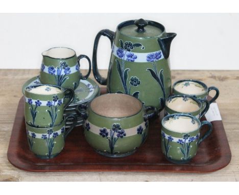 A late Victorian Florian ware tea service, designed by William Moorcroft for Macintyre, comprising teapot, cream jug, sugar b