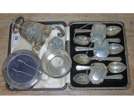 A mixed lot of hallmarked silver comprising a cased set of Art Deco style teaspoons, three decanter labels, sugar tongs, crea