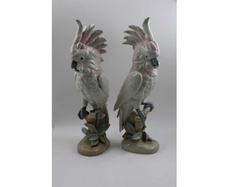 A pair of Royal Dux ceramic cockatoos, modelled perched upon branches, factory marks beneath base include the pink triangle f
