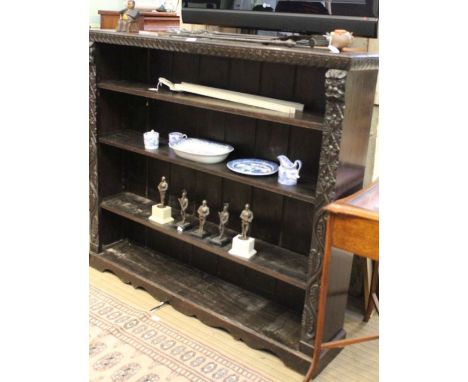 A 19th century oak set of book shelves with carved surround 122 x 138 cm.