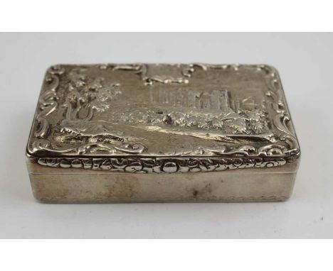 A William IV silver snuff box, the hinged cover decorated with a raised image of a grand country house in a parkland setting,