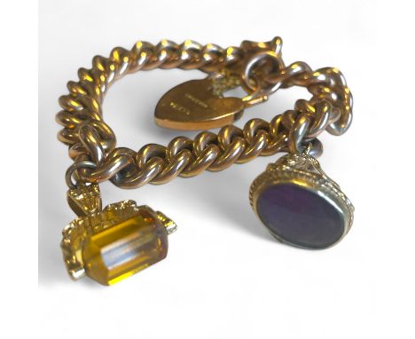 A "9ct" stamped hollow link chain bracelet, with 9ct rose gold heart padlock clasp and two fob charms. Testing as 9ct gold. A