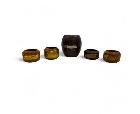 A collection of various items made from ship's timbers, comprising a miniature barrel, and four napkin rings, each with a pla