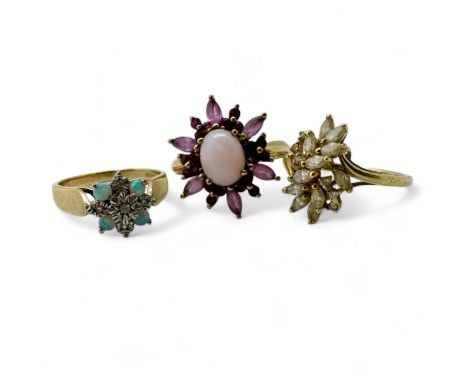 A group of three gold gem set dress rings. Comprising a 9ct gold opal and illusion set diamond dress ring, size N1/2; a 14ct 