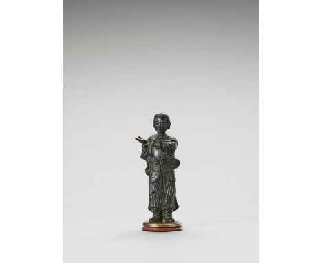 A BRONZE FIGURE OF A LUOHAN, MINGChina, Ming dynasty (1368-1644), 17th century. Depicting a standing Luohan pointing towards 