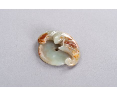 A CELADON AND RUSSET JADE 'BAT AND COIN' PENDANT, LATE QINGChina, late Qing dynasty (1644-1912). Neatly carved as a bat with 