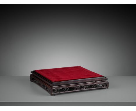 A LARGE OPENWORK HARDWOOD SQUARE BASE, QING DYNASTYChina, 19th century. The tiered base supported on four small feet and fine