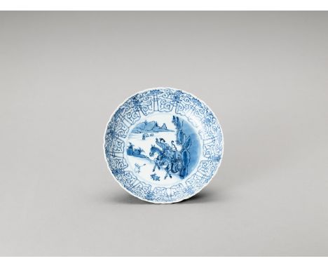 A BLUE AND WHITE PORCELAIN DISHChina, Kangxi period (1662-1722). The deep dish slightly lobed, like the pointed end of a lotu