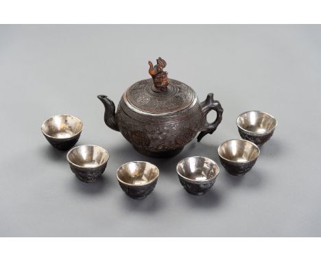 A CONONUT AND SILVER TEA SETChina, 19th century. Lovely set of six bowls and a lidded teapot, carved from coconut shell with 