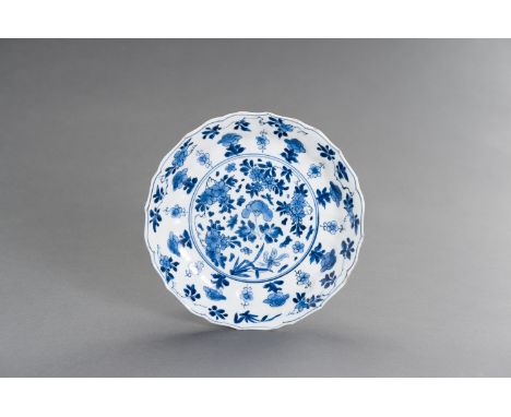A BLUE AND WHITE PORCELAIN 'FLORAL' LOBED AND BARBED-RIM BOWL, KANGXI MARK AND PERIODChina, Kangxi period (1662-1722). The sh