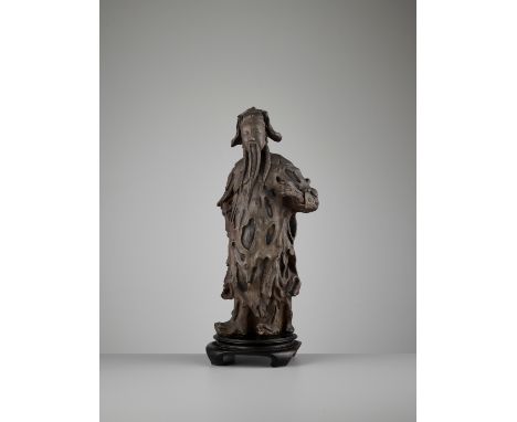 A YIXING ZISHA FIGURE OF AN IMMORTAL, 17TH-18TH CENTURYChina, late Ming to early Qing dynasty. The finely modeled clay body i