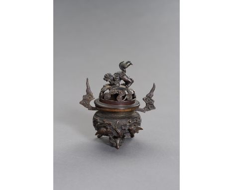 A CHINESE MINATURE BRONZE TRIPOD CENSERChina, 19th century. The miniature bronze tripod censer with birds and flowers in high