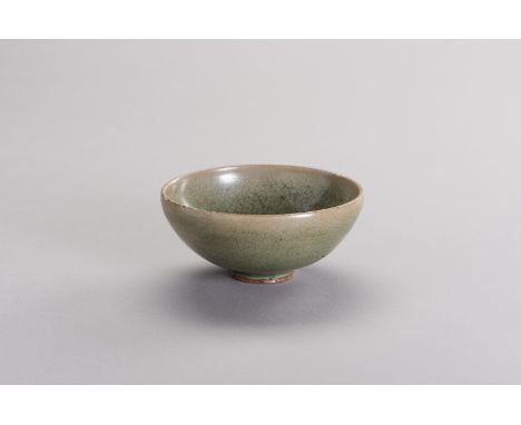 A LONGQUAN CELADON-GLAZED BOWLChina, Song - Yuan dynasty, 13th- 14th century. Potted with rounded sides and raised on a short