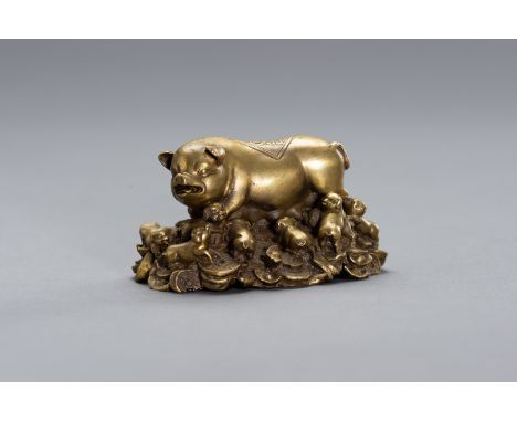 A BRONZE LUCKY CHARM OF A SOW WITH HER YOUNGChina, Republic period (1912-1949). An appealing depiction of a sow lying on a pi