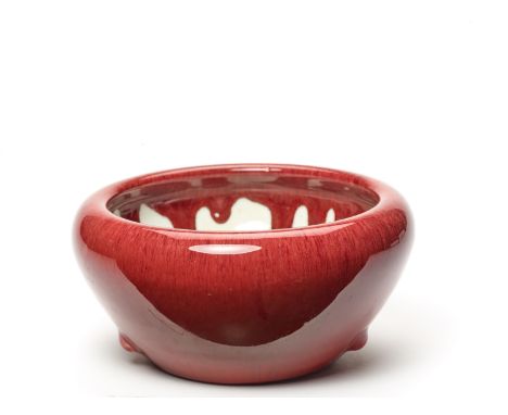 A MASSIVE OXBLOOD GLAZED CERAMIC BOWL, QING DYNASTYChina, 18th - 19th century. The outside with three raised knobs and a conv