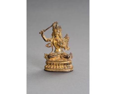 A GILT BRONZE FIGURE OF MANJUSHRISino-Tibetan, late 19th century. The gilt bronze buddha figure of Manjushri with finely inci