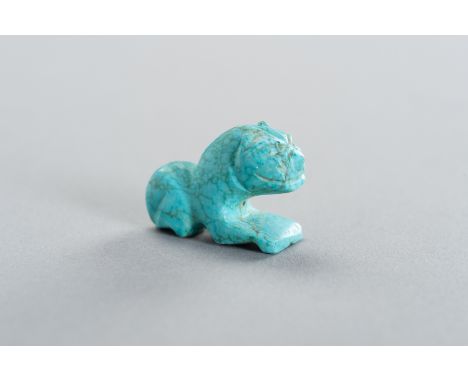 AN ANCIENT STYLE TURQUOISE TIGER AMULETPersia, 19th century or earlier. The stone carved as a tiger, with a central drilling.