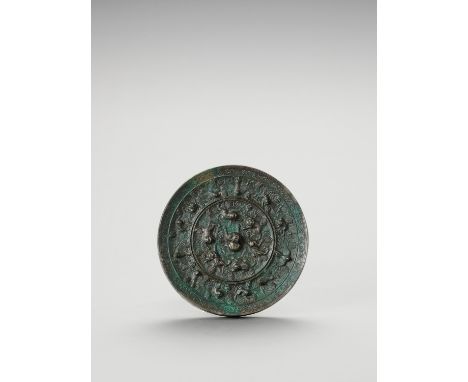 A LARGE CIRCULAR BRONZE 'LION AND GRAPEVINE' MIRRORChina, late Qing dynasty. The Tang style mirror is cast in the centre with