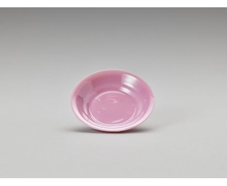 A PINK PEKING GLASS DISHChina, Qing Dynasty (1644-1912). Shaped with a flared rim and raising from a ring foot. The opaque gl