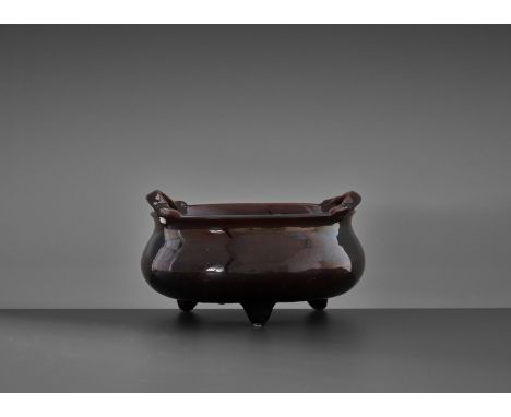 A LARGE AUBERGINE-GLAZED 'BOMBE' TRIPOD CENSER, QING DYNASTYChina, 18th to early 19th century. The compressed globular body s