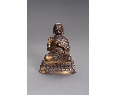 A BRONZE PORTAIT FIGURE OF A LAMATibetan-Chinese, late Qing to Republic period (1880-1950). Seated in dhyanasana on a sealed 