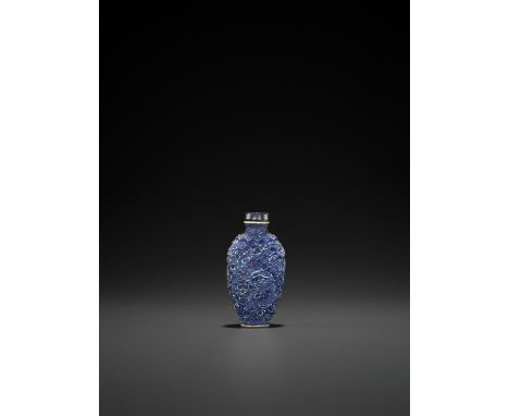 A MOLDED AND GLAZED PORCELAIN 'DRAGON AND PHOENIX' SNUFF BOTTLE, QINGChina, 19th century. The elongated ovoid body rising fro