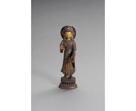 A FINE BONZE FIGURE OF DIPAMKARANepal, 19th century. The bronze buddha figure of Dipamkara, inlaid with corals and turquoises