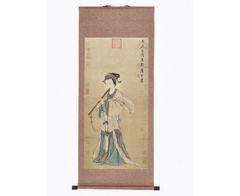 A HANGING SCROLL PAINTING OF A LADY PLAYING A FLUTEChina, late Qing Dynasty (1644-1912). Painted in various colors on paper, 