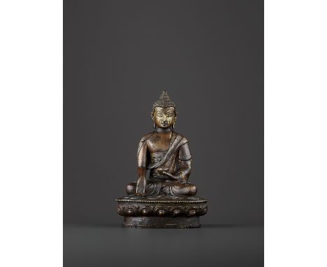 A BRONZE BUDDHA SHAKYMUNIChina, late 19th century. The figure seated on a beaded lotus base in dhyanasana and dressed in fine