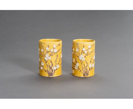 A PAIR OF YELLOW GLAZED BRUSHPOTS WITH APPLIED DECORATIONS, LATE QINGChina, late Qing dynasty (1644-1912). Each of cylindrica