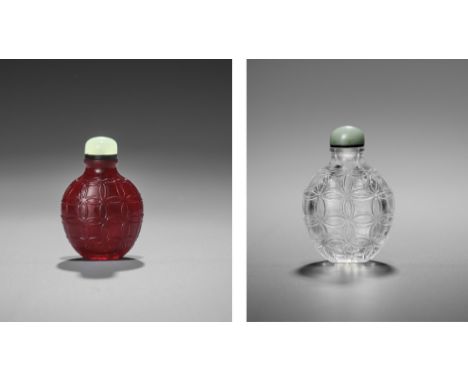 A RARE SET OF TWO GLASS SNUFF BOTTLES, QING DYNASTYChina, 18th-19th century. One translucent ruby red and one transparent gla