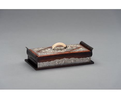 A ROSEWOOD AND SILVER JEWERLY BOX WITH COVER AN IVORY HANDLEVietnam, c. 1920. Of elegant, rectangular form with two S-shaped 