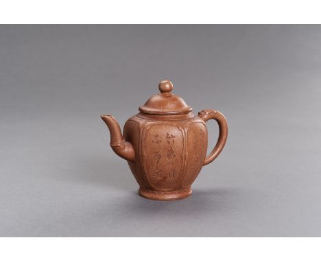 A YIXING CERAMIC TEAPOT AND COVERChina, 20th century. The hexagonal baluster teapot with a handle in form of a stylized drago