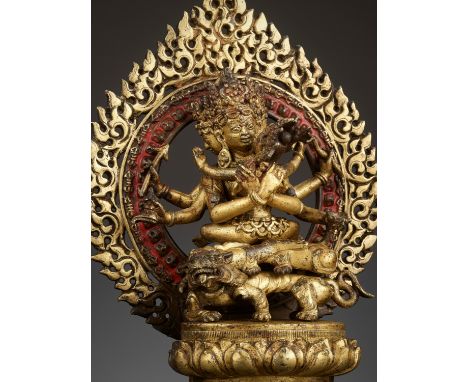 A GILT-BRONZE FIGURE OF GUHYASAMAJA IN A GILT-BRONZE SHRINETibet, 16th-17th century. Guhyasamaja is seated in vajrasana, on a