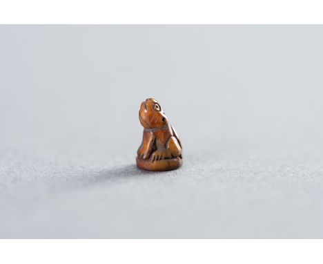 A MINIATURE TOOTH TIGER AMULETThailand, early 19-20th century. Charming miniature depiction of a tiger sitting on his hind pa