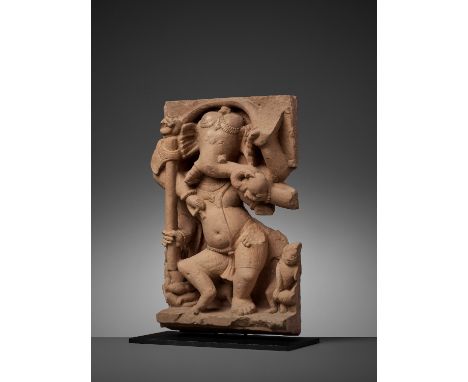 A SANDSTONE STELE OF GANESHACentral India, 11th century. The six-armed elephant-headed god dancing with his arms radiating, h