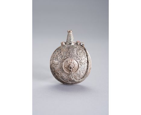 A GUNPOWDER SILVER FLASKChina, 19th century. The circular body embossed and engraved with Buddhist symbols, with original lid