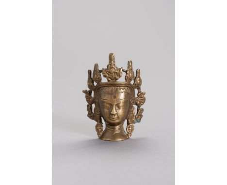 A MINIATURE BRONZE HEAD OF BODHISATTVATibet, 17th to 18th century. The bronze bodhisattva head with visible remains of gildin