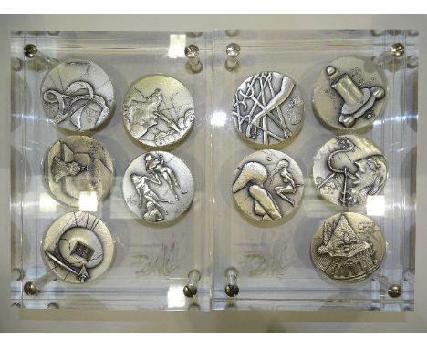 A set of ten silver Salvador Dali's 'The Ten Commandments' medals, each medal 5cm diameter, with Dali's signature, dated 1975