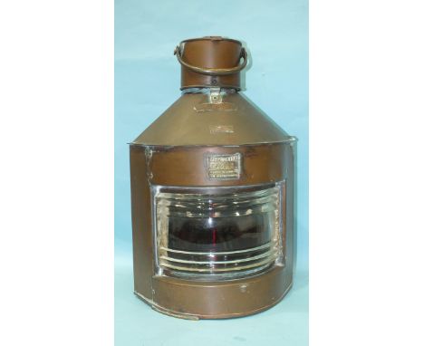 A copper and brass masthead "Port" lamp labelled Meteorite 71503 by W T George &amp; Co. Ltd, 56cm, (63cm with handle). 