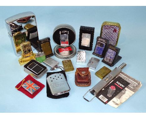 A collection of eight Zippo lighters of plain or engraved decoration, a large chromium-plated Zippo-style lighter, 17 x 11cm,